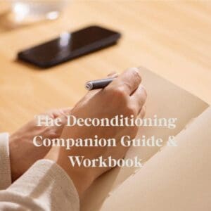 Deconditioning Companion Guide & Workbook title on a background of someone's hand writing on a journal